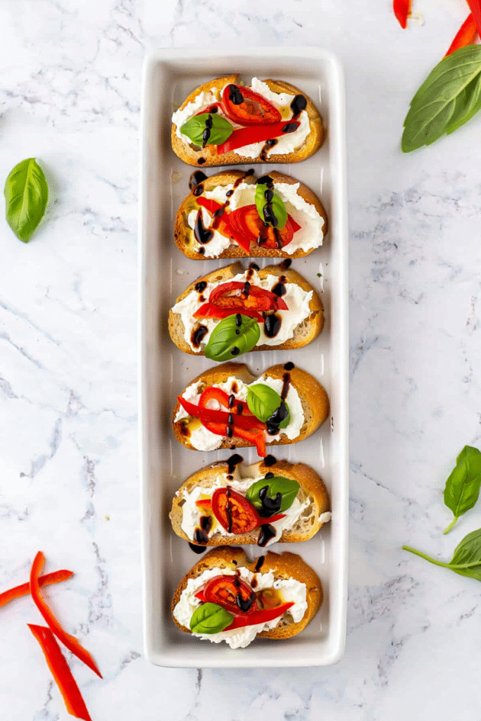 20 Christmas Appetizer Ideas to Elevate Your Holiday Spread 8 Roasted Red Pepper and Goat Cheese Crostini